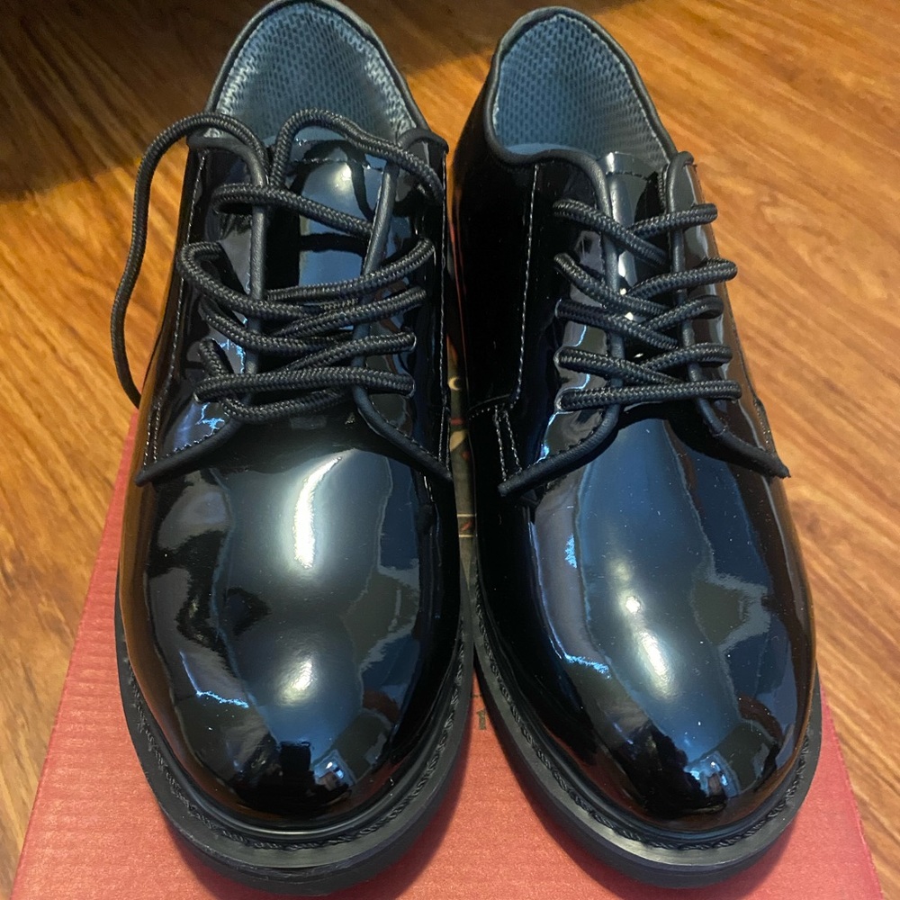 Black shiny uniform shoes.